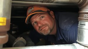 man looking at something - maintenance for water softener system